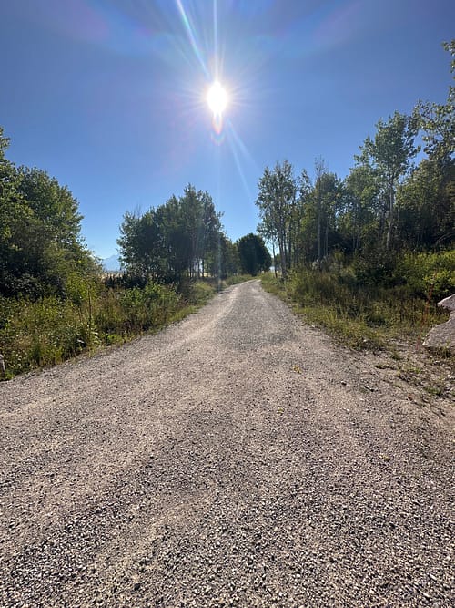 Darby Pit, Gravel & Trucking - Our company specializes in providing high-quality materials such as dirt, sand, gravel, and crushed stone. We offer comprehensive trucking services for all your excavation, landscaping, construction of roads and paths, driveways, and foundation needs.

Imagine a gravel trail extending into the horizon under a radiant sun with rays shining brightly. It's surrounded by lush green trees on a perfectly clear day. The roadbase is solid with 3/4” Minus Crush material—ideal for cyclists to conquer their weekend goals effortlessly.

Whether you're building homes or embarking on large-scale landscaping projects, we ensure you have the right materials delivered efficiently to get the job done right.