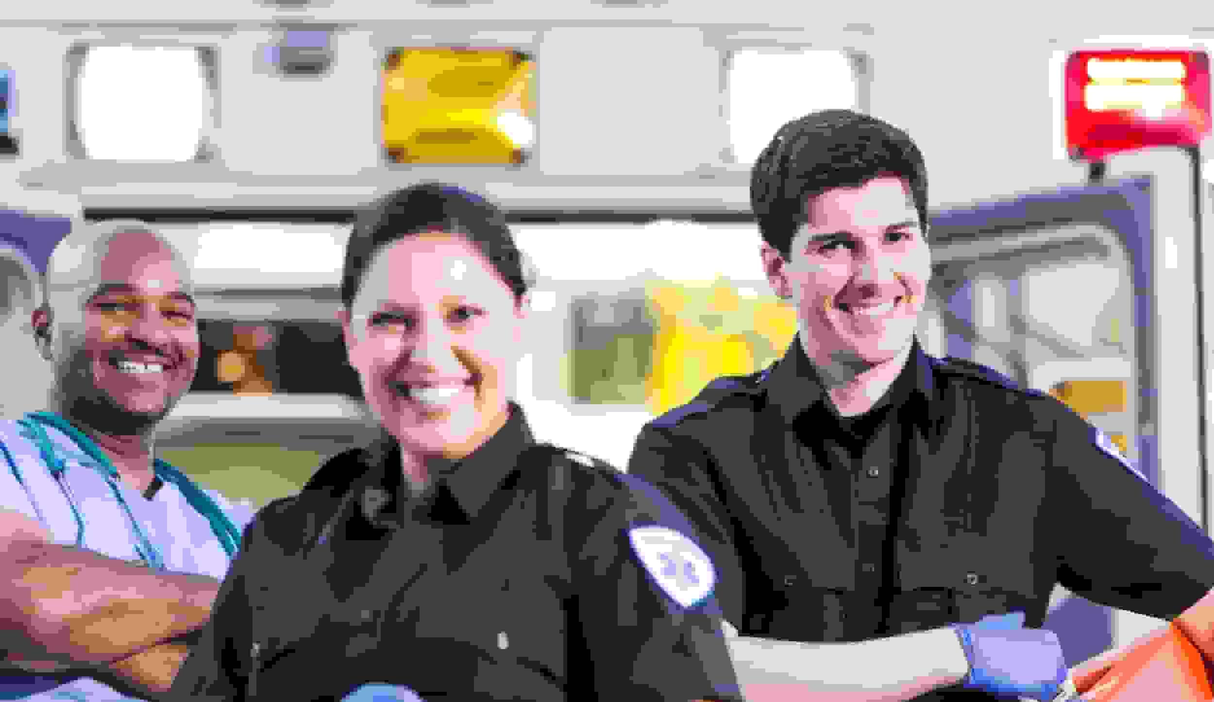 Paramedics and doctor outside ambulance