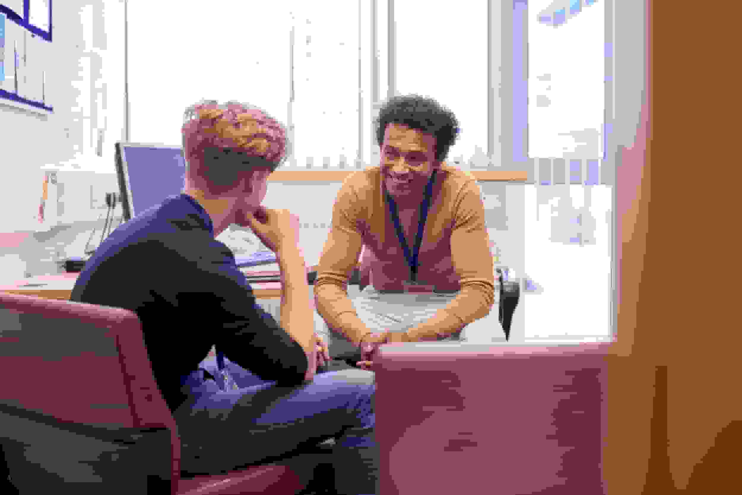 Male college student meeting with campus counselor discussing mental health issues