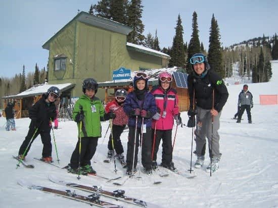 Teton Valley Non-Profits, Six children, clad in vibrant ski gear, gather joyfully outside a picturesque mountain lodge on a snow-dusted slope. Each child grips their ski poles eagerly, ready for adventure. Majestic trees and charming buildings form the serene backdrop, highlighting the dynamic community that thrives here. This scene is made possible by the Community Foundation of Teton Valley's unwavering support for local non-profits and businesses through thoughtful charitable giving. By investing in programs that enrich lives and promote outdoor activities, the foundation fosters a spirit of togetherness and ensures opportunities for recreation are accessible to all residents and visitors alike. The Tin Cup Challenge & Run is the CFTV annual giving event day.