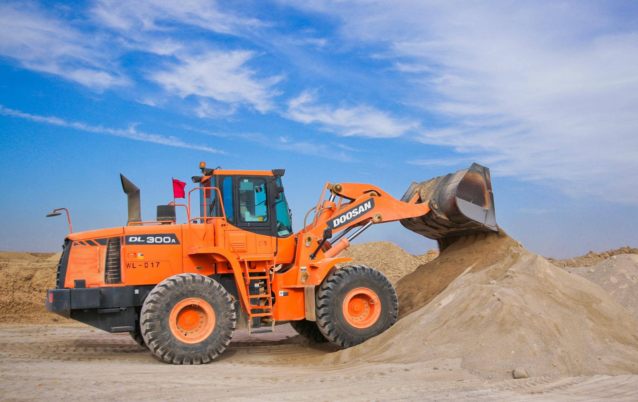 Darby Pit, Gravel & Trucking - We specialize in supplying top-quality materials including dirt, sand, gravel, and crushed stone for all your construction and landscaping needs. Whether you're undertaking excavation projects, constructing driveways, creating pathways, building foundations or working on any home improvement tasks, we have the right materials for you. 

In addition to our extensive inventory of aggregates, we offer reliable and efficient trucking services tailored to support excavation and material transportation needs for both residential builders and large-scale construction operations.

Picture this: an orange bulldozer loader with its bucket raised high efficiently scooping sand on a busy construction site under a bright blue sky dotted with scattered clouds – the perfect image encapsulating the robust solutions we provide for your next big project.