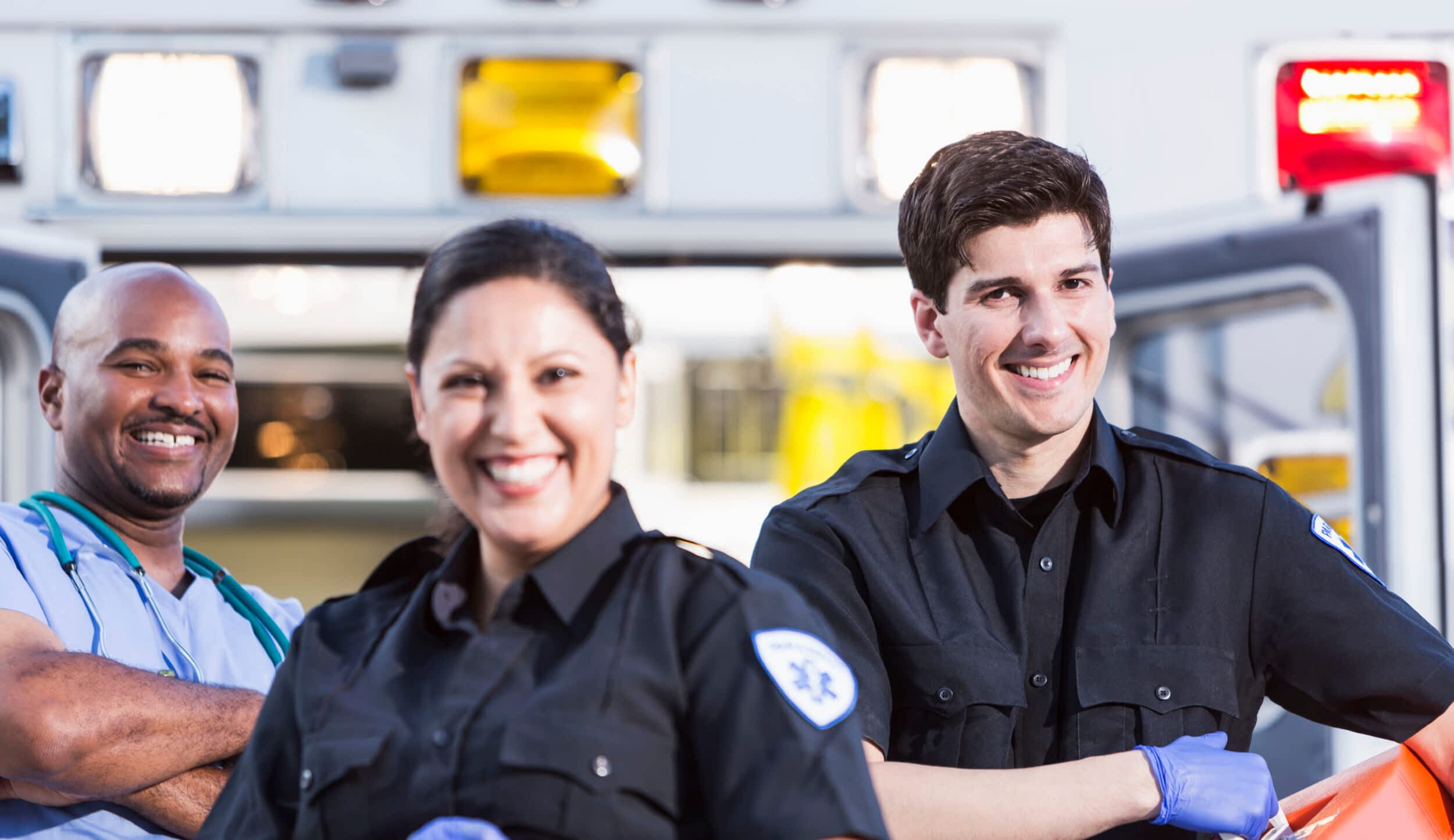 Paramedics and doctor outside ambulance