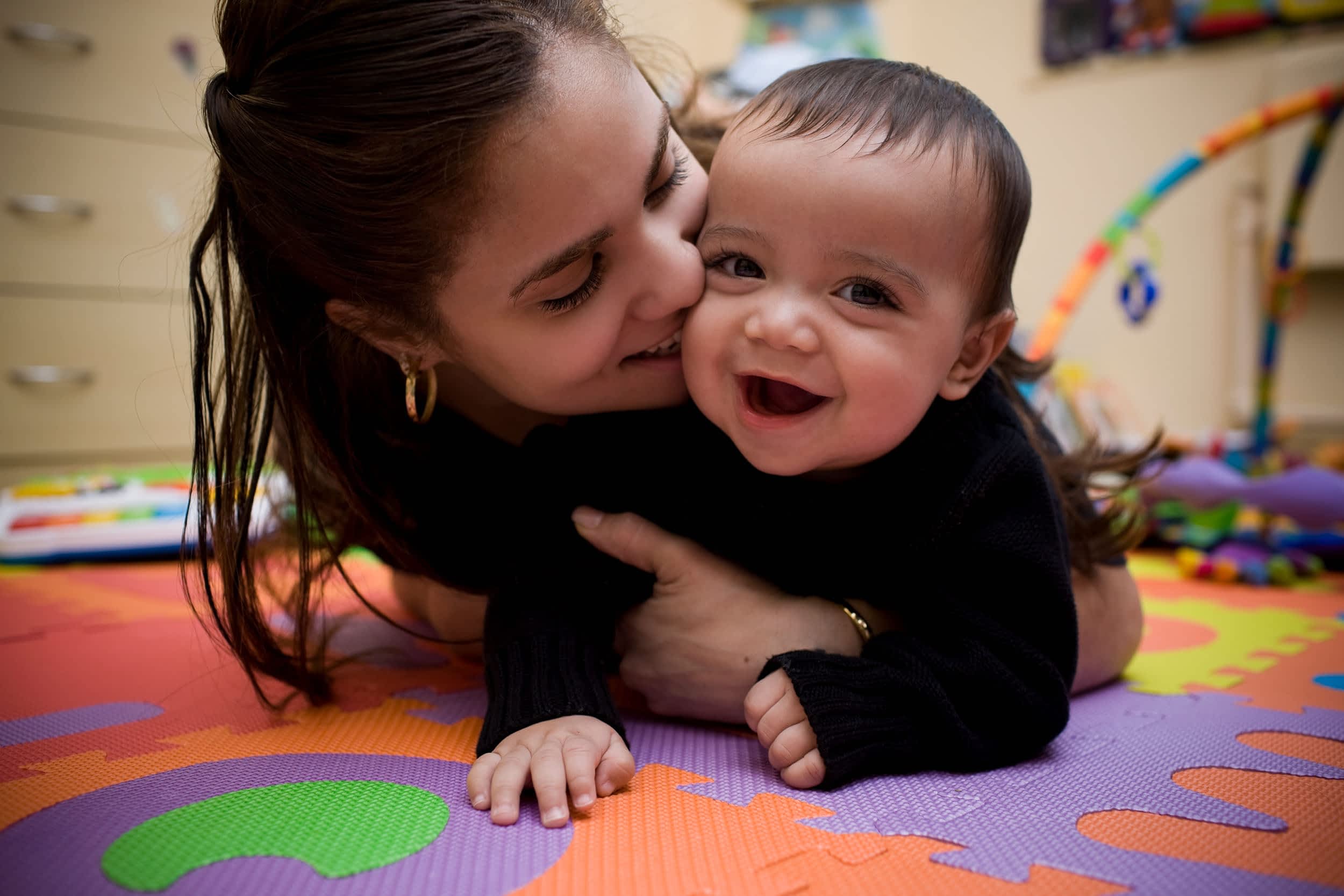 Adorable Hispanic Young Mother and Son in Home Playroom