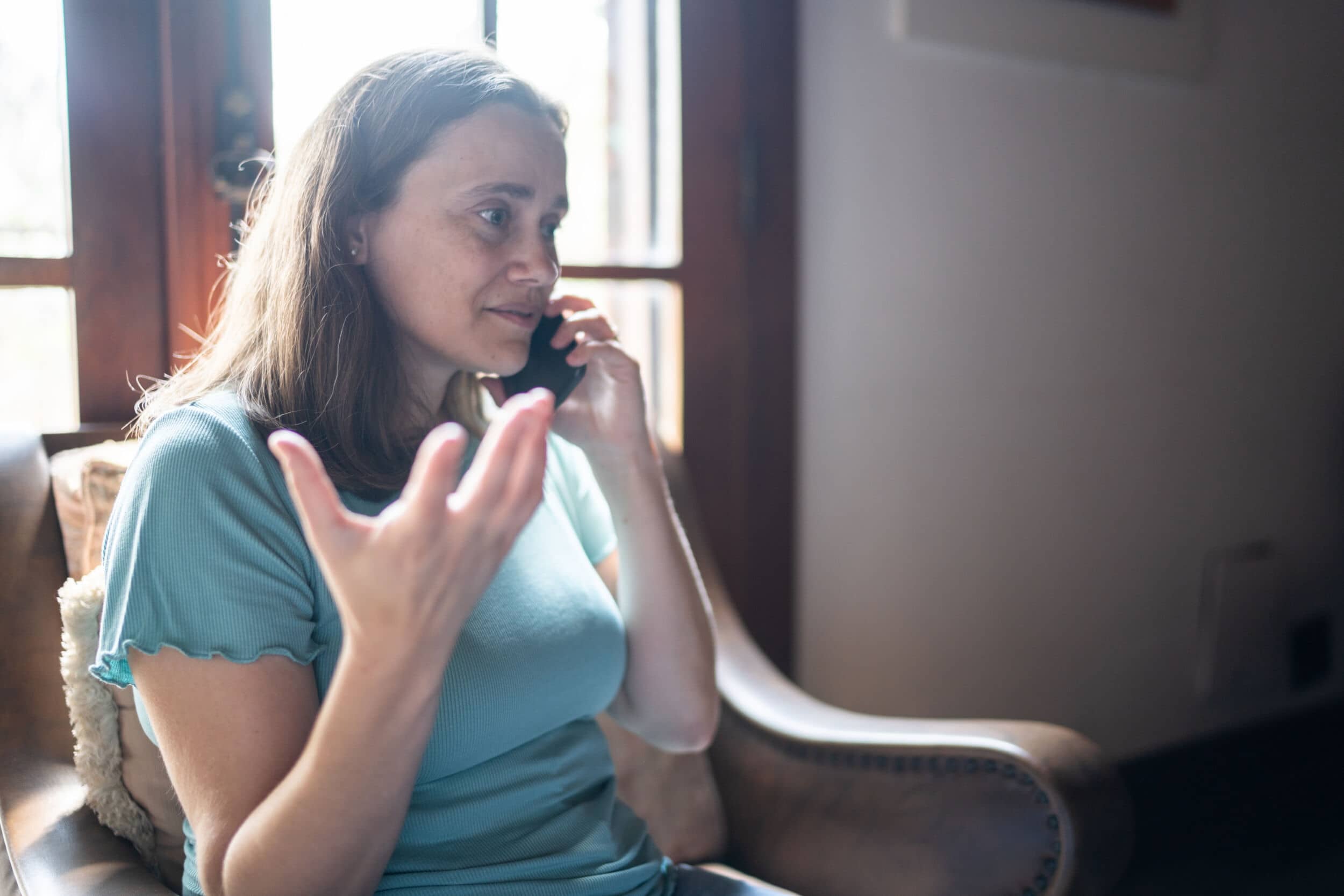 Mature Woman Talking On The Smartphone At Home