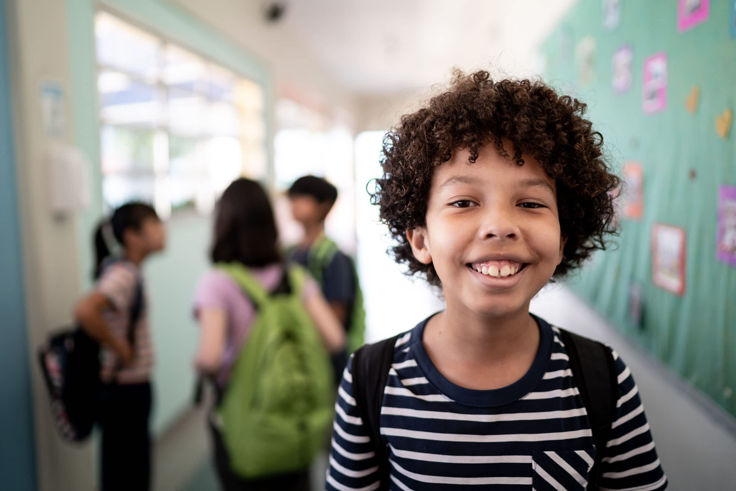 Portrait of a boy in the corridor at school