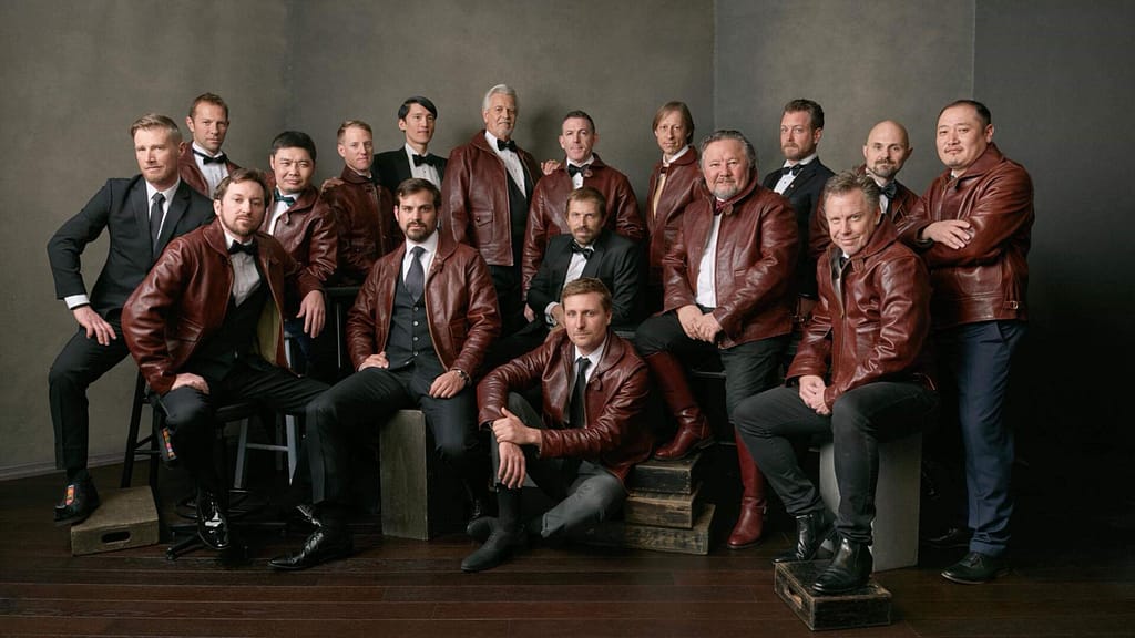 Group portrait of a crew in matching jackets on set